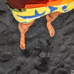 Feet on Black Sand Beach Punlaluu Big Island Hawaii 1