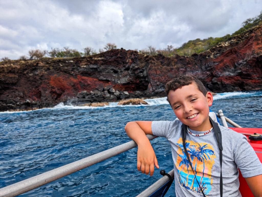 Taylor Family on skiff at Lava Cliff Kona Coast from Skiff with UnCruise Safari Explorer Big Island Hawaii 2