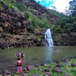 Taylor Family swimming at Waterfall at Waimea Valley North Shore Oahu Hawaii