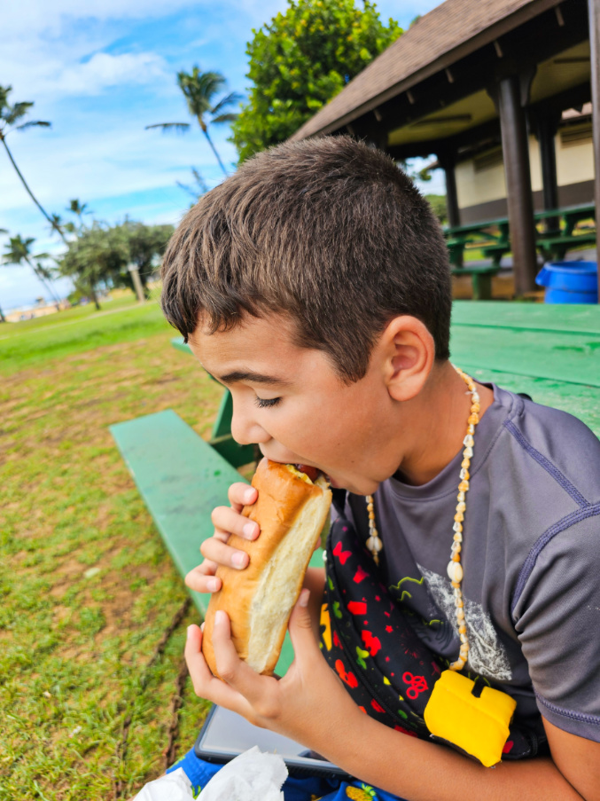 Taylor Family eating Puka Dogs at Poipu Beach South Shore Kauai 1