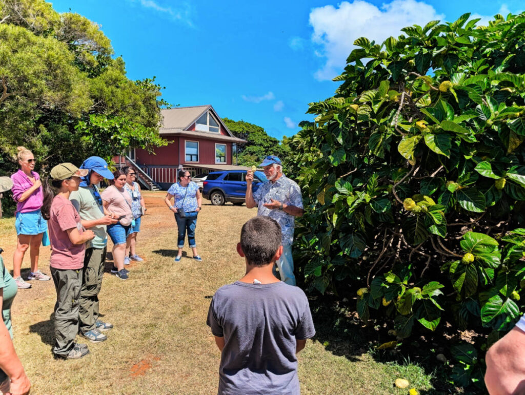Taylor Family with Noni Fruit in orchard at Real Noni Farm Tour Kilauea Kauai Hawaii 1