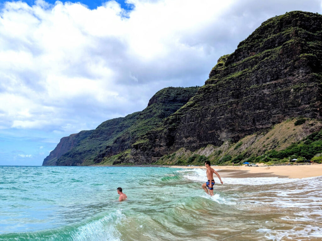 Taylor Family swimming at beach on Na Pali Coast Polihale State Park Kauai Hawaii 3