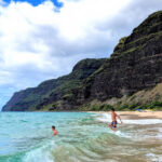 Taylor Family swimming at beach on Na Pali Coast Polihale State Park Kauai Hawaii 3