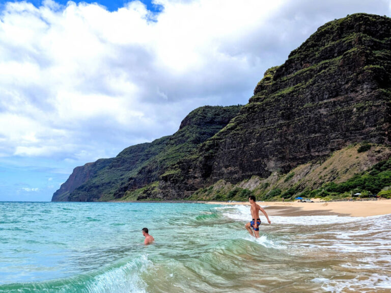 Taylor Family swimming at beach on Na Pali Coast Polihale State Park Kauai Hawaii 3